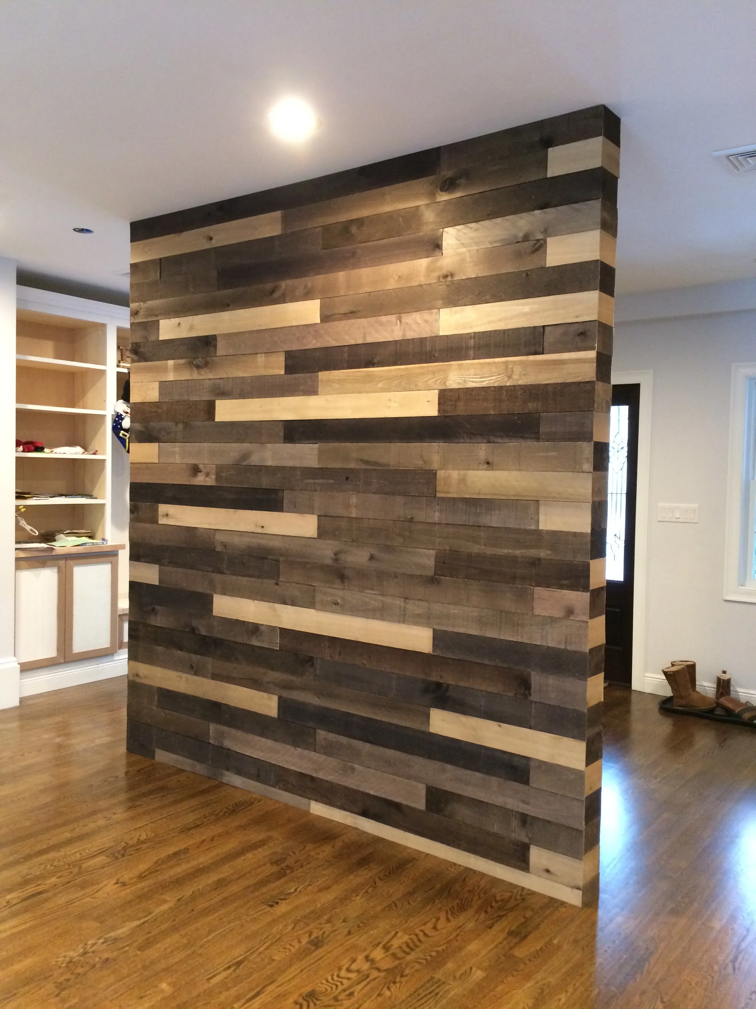 Finished custom wood accent wall with mixed-tone planks