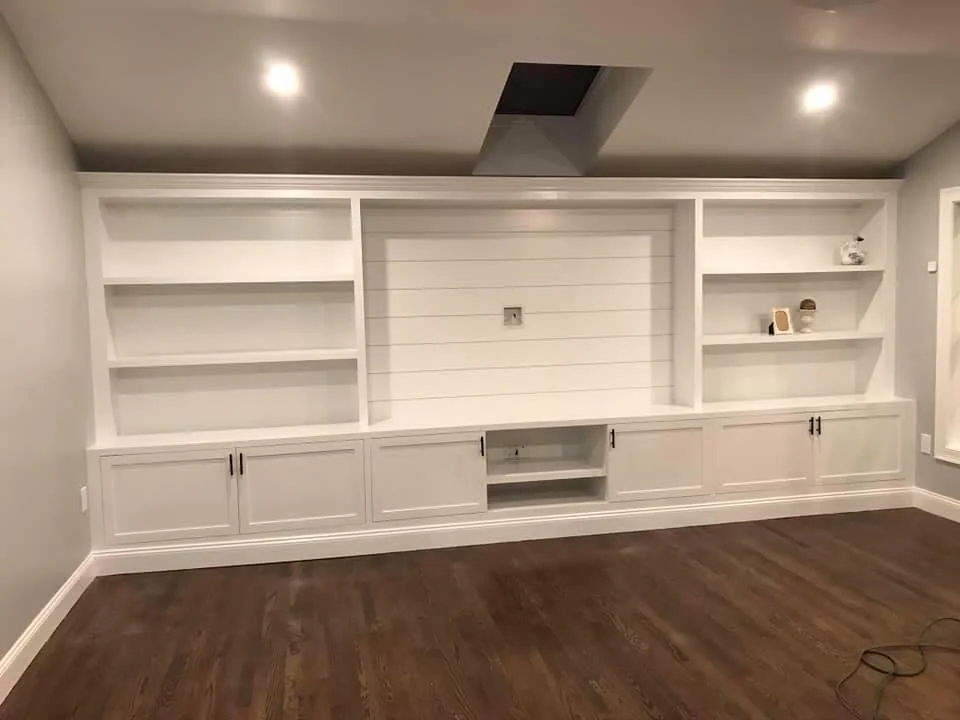White built-in media cabinets with shelves and shaker doors