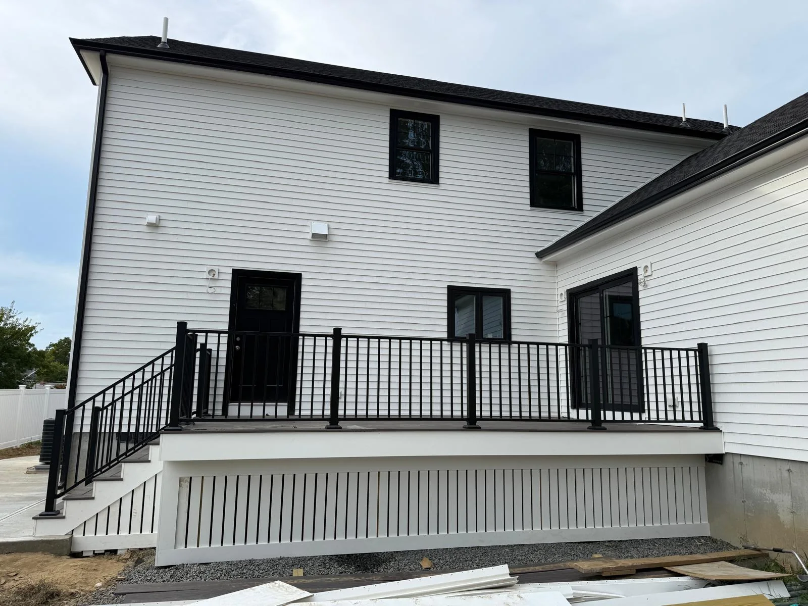 Finished composite deck with black railings on a Greater Boston home