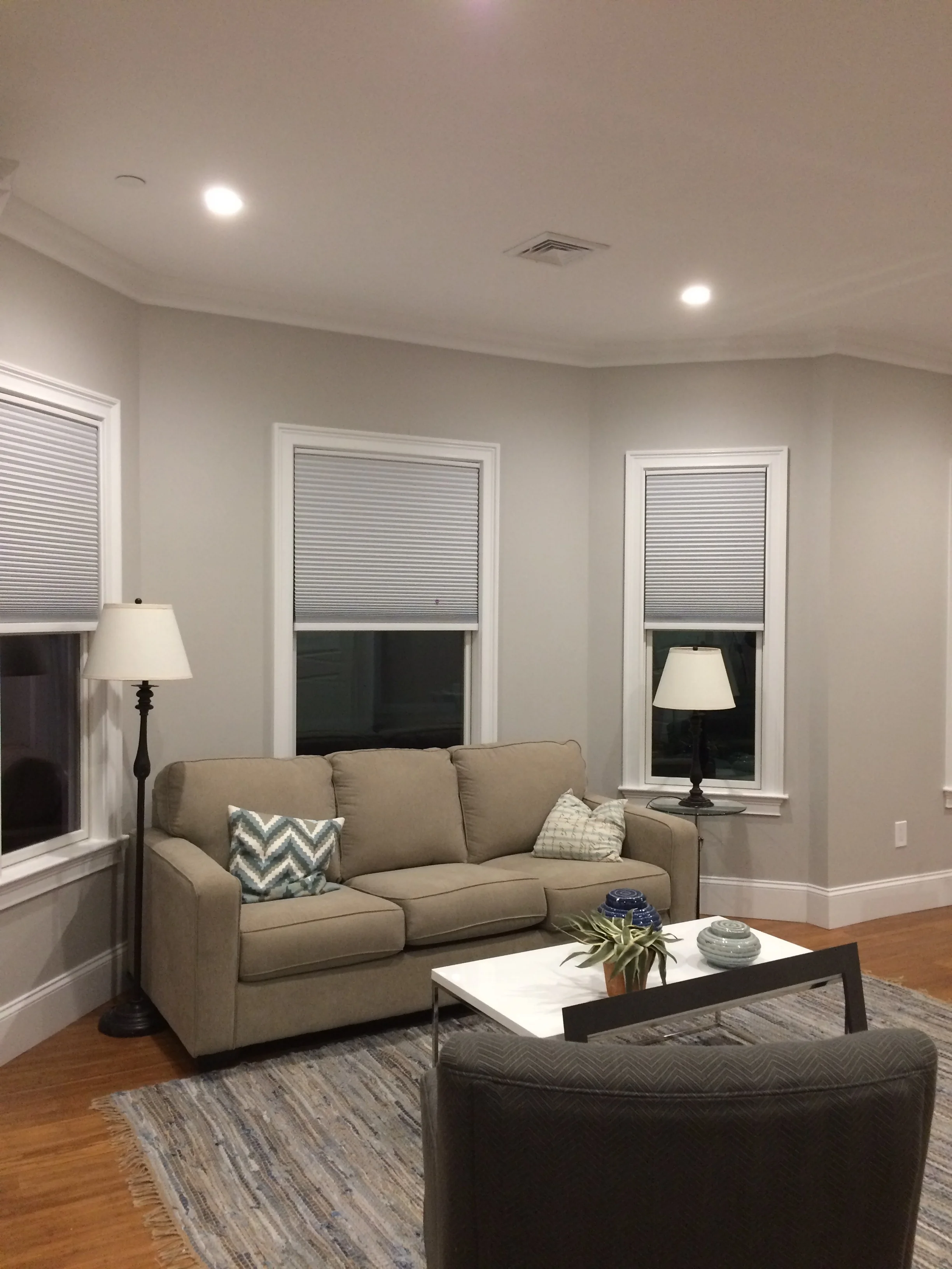 Living room with crown molding, window trim and finished baseboards